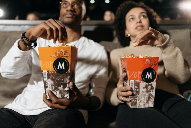 People watching movies and eating popcorn
